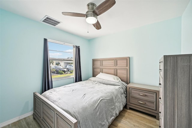 bedroom featuring light hardwood / wood-style floors and ceiling fan