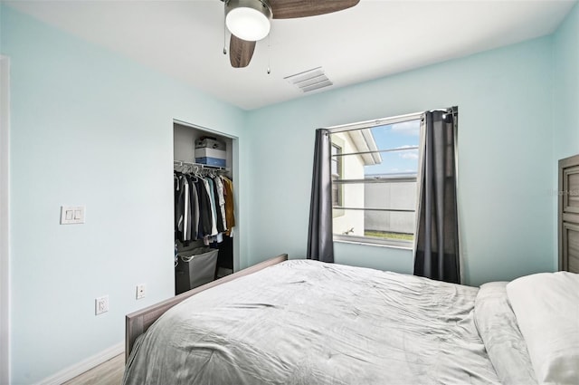 bedroom featuring hardwood / wood-style flooring, ceiling fan, and a closet