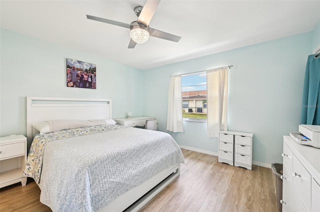 bedroom with light hardwood / wood-style flooring and ceiling fan