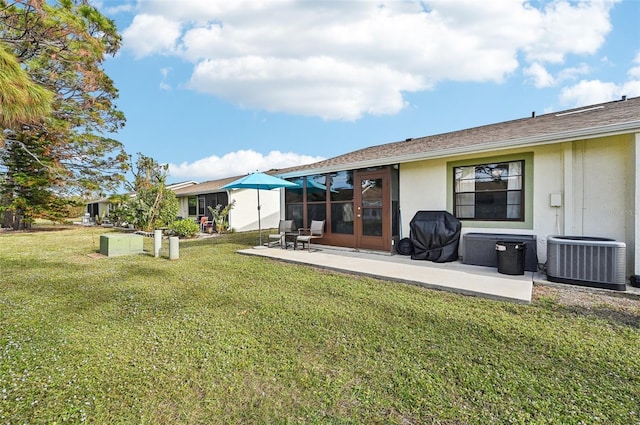 back of property featuring cooling unit, a patio area, and a lawn