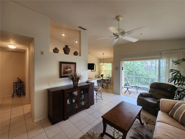 living room featuring lofted ceiling, ceiling fan, and light tile patterned flooring