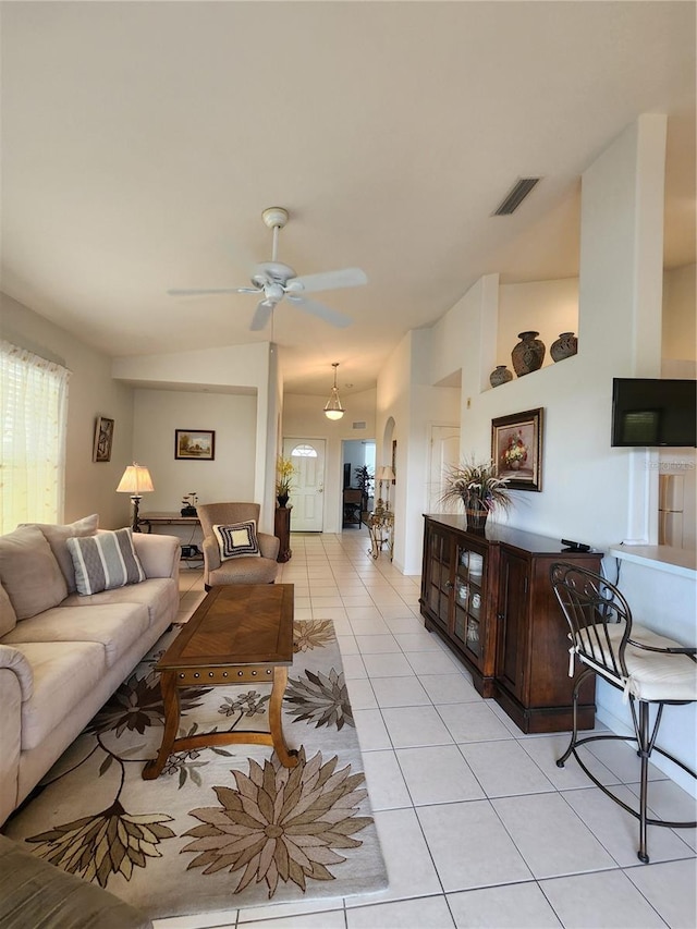 tiled living room featuring vaulted ceiling and ceiling fan