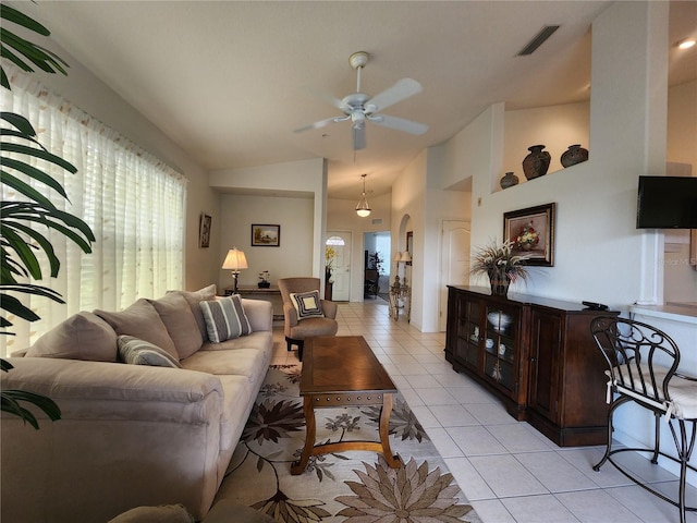 living room featuring light tile patterned floors, vaulted ceiling, and ceiling fan