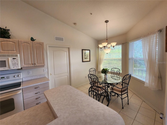 kitchen featuring light tile patterned floors, white appliances, decorative light fixtures, vaulted ceiling, and light brown cabinets