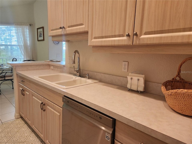 kitchen featuring light brown cabinetry, sink, light tile patterned floors, and dishwasher