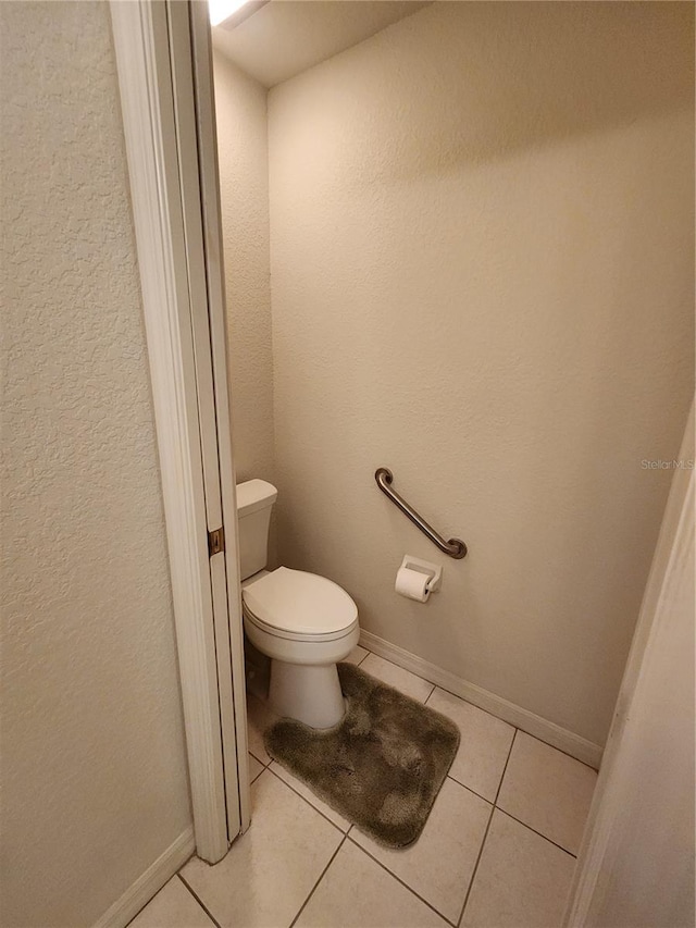 bathroom featuring tile patterned floors and toilet