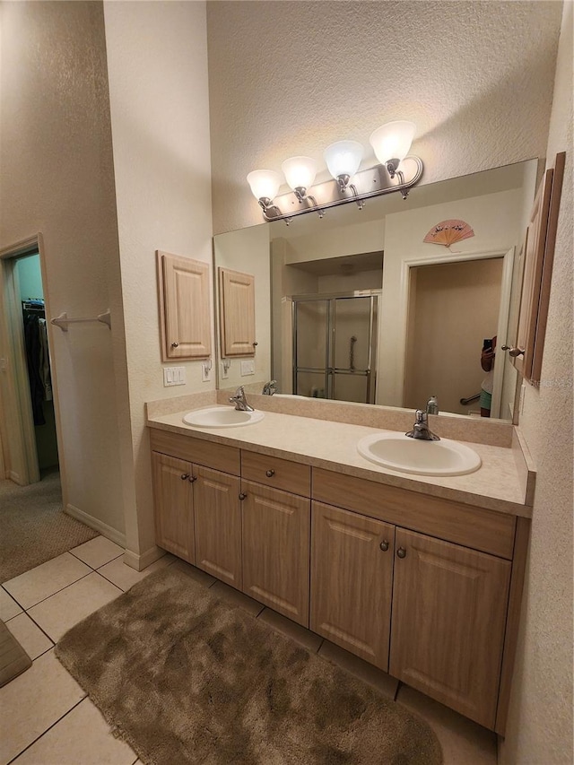 bathroom with vanity, tile patterned floors, and a shower with shower door