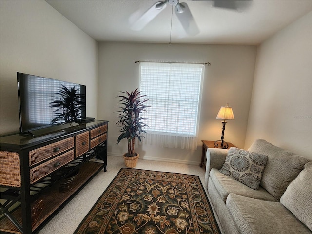 carpeted living room featuring ceiling fan