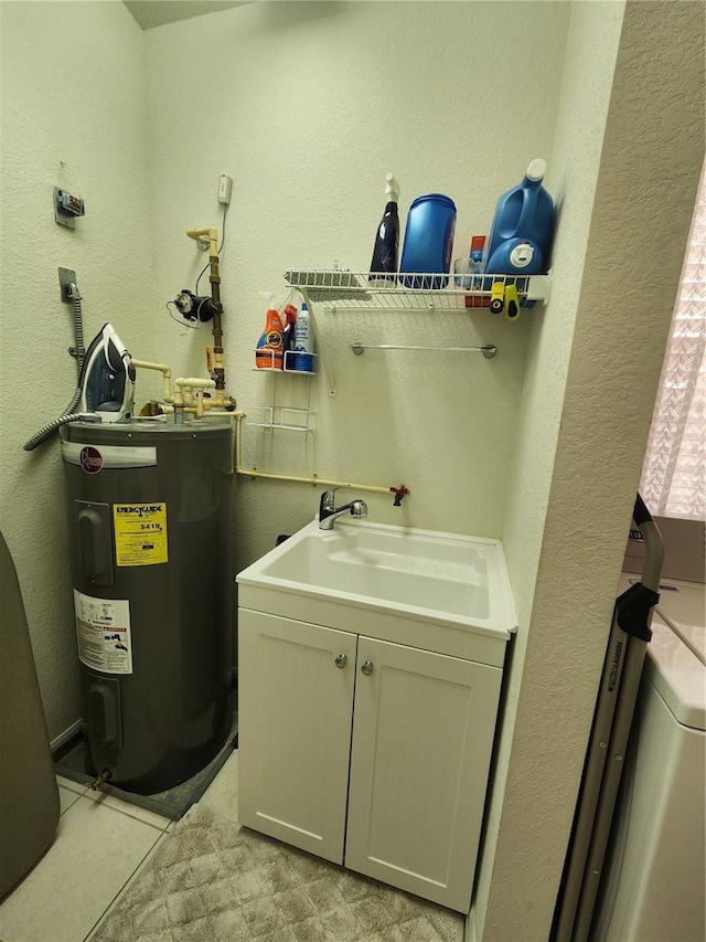 washroom featuring water heater, sink, and cabinets