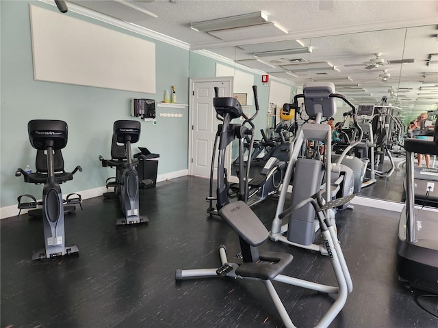 gym with ornamental molding and a textured ceiling