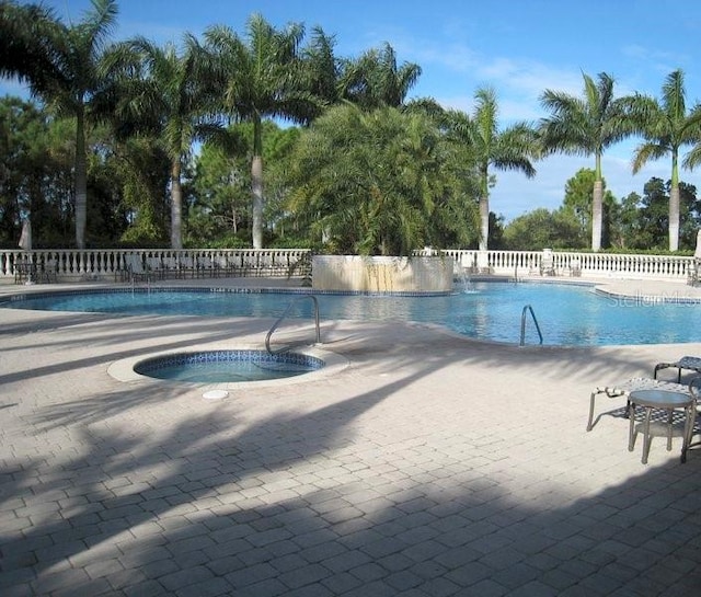 view of pool with a community hot tub and a patio