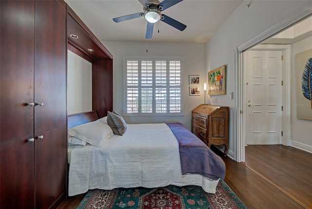 bedroom with ceiling fan and dark hardwood / wood-style floors