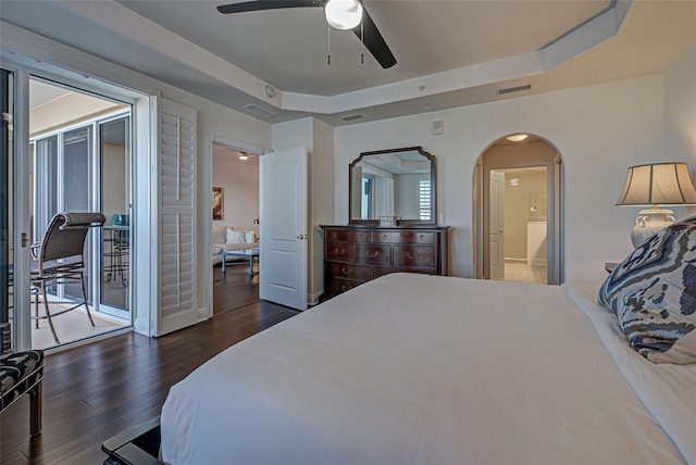 bedroom featuring access to outside, a raised ceiling, ceiling fan, and dark wood-type flooring