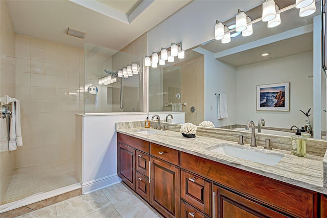 bathroom featuring tiled shower and vanity