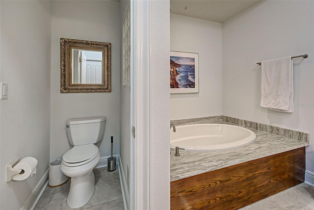 bathroom featuring tile patterned floors, a bathtub, and toilet