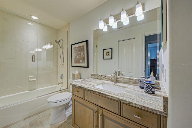 full bathroom with combined bath / shower with glass door, vanity, toilet, and tile patterned flooring