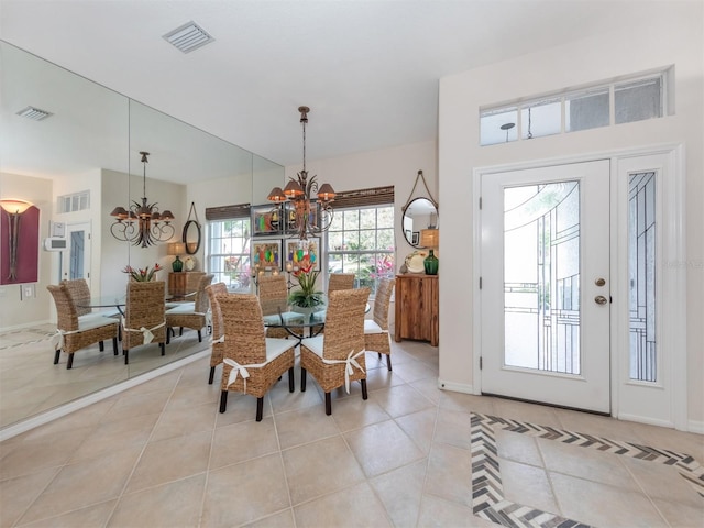 tiled dining space with a notable chandelier