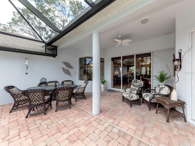 view of patio featuring glass enclosure and ceiling fan