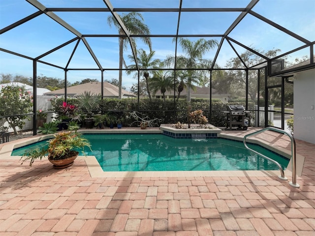 view of pool featuring glass enclosure, a patio, and grilling area