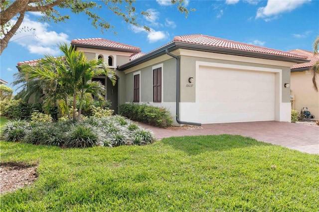 view of property exterior with a garage, a yard, a tile roof, and stucco siding