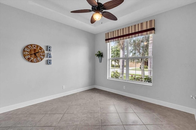 spare room featuring ceiling fan and light tile patterned floors