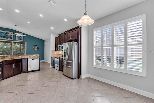 kitchen featuring appliances with stainless steel finishes, decorative light fixtures, and a healthy amount of sunlight