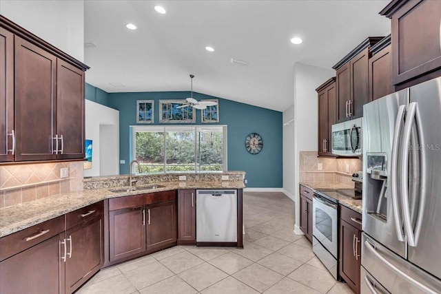 kitchen with sink, vaulted ceiling, decorative backsplash, ceiling fan, and stainless steel appliances