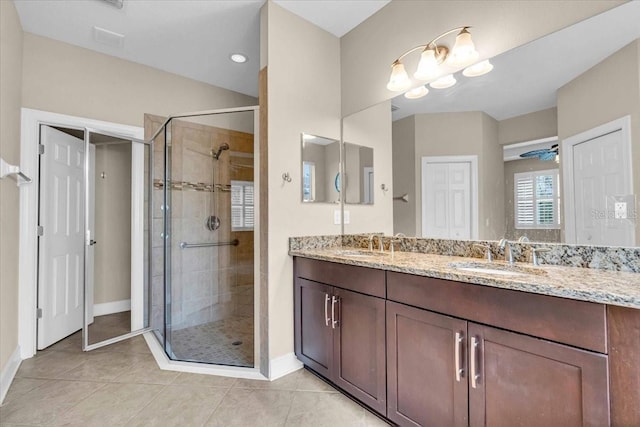 bathroom with tile patterned floors, vanity, ceiling fan, and walk in shower