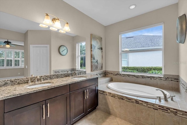 bathroom with ceiling fan, plenty of natural light, and tile patterned flooring