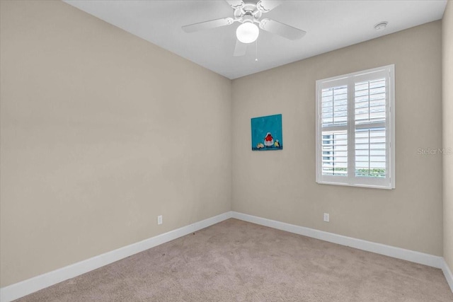 empty room featuring light carpet and ceiling fan