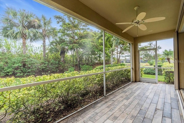 unfurnished sunroom featuring ceiling fan