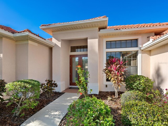 view of exterior entry featuring french doors