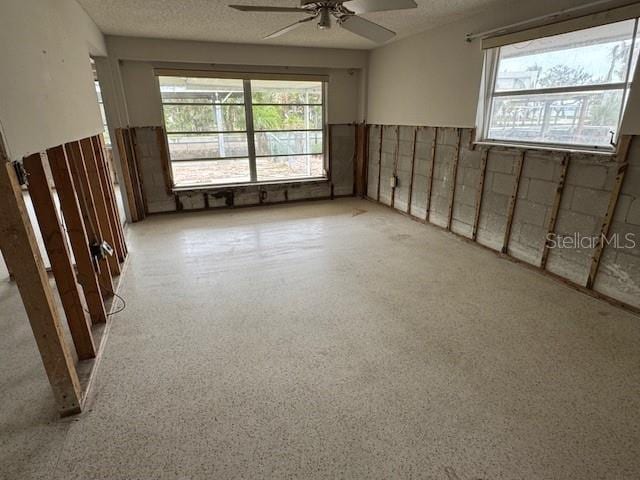 unfurnished room featuring a textured ceiling and ceiling fan