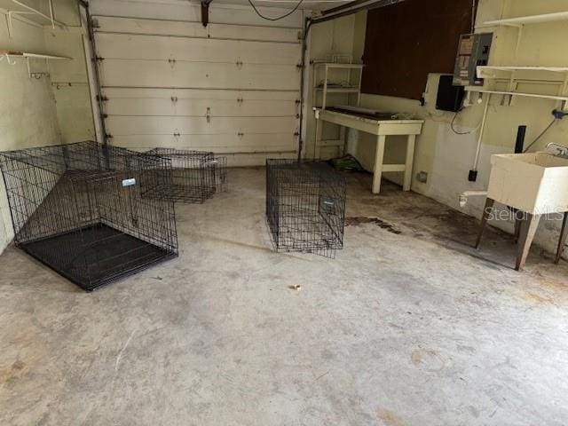 garage featuring electric panel and sink