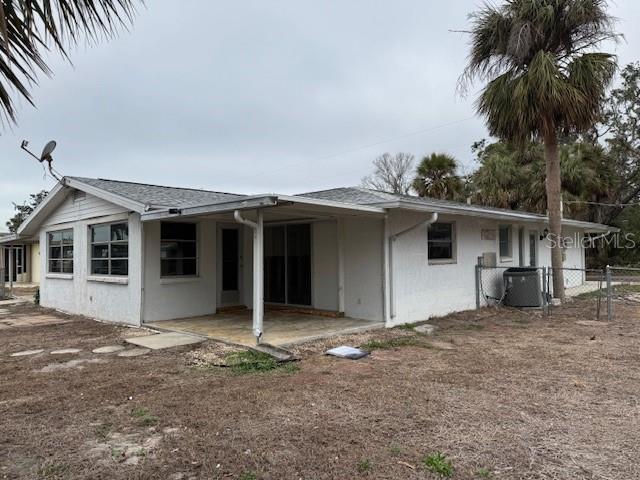 back of property featuring a patio and cooling unit