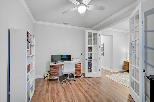 office with french doors, light hardwood / wood-style floors, ceiling fan, and ornamental molding