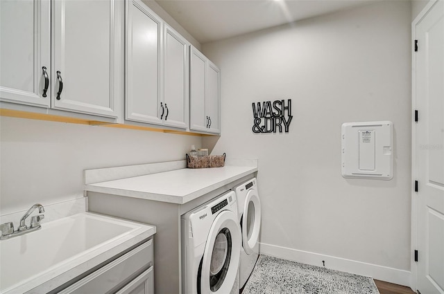 washroom featuring cabinets, independent washer and dryer, light wood-type flooring, and sink