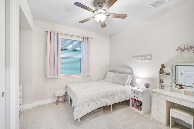 bedroom with ceiling fan and light carpet