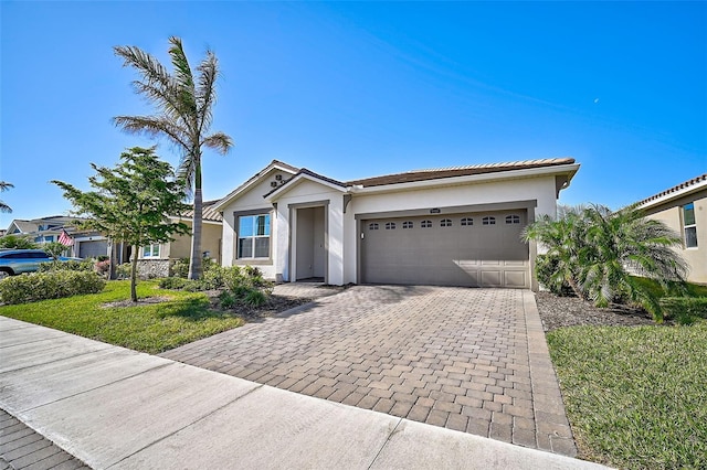 ranch-style house featuring a garage and a front lawn