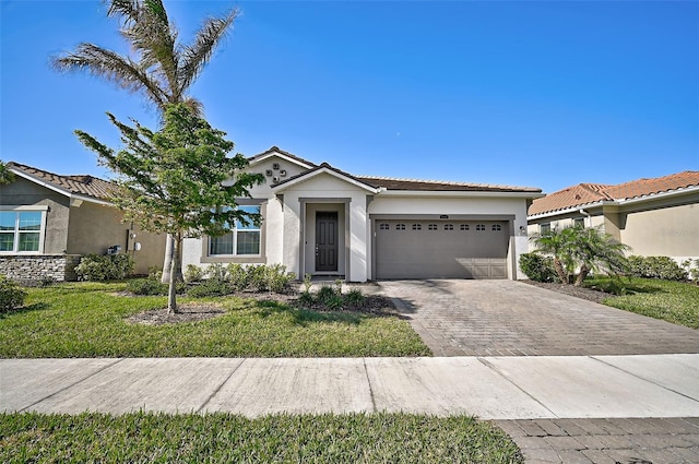 view of front of property with a garage and a front lawn