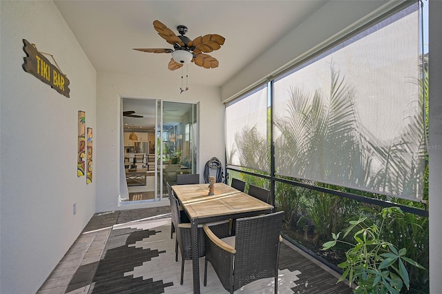 sunroom / solarium featuring ceiling fan