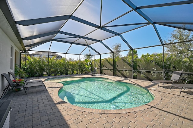 view of swimming pool with a lanai and a patio