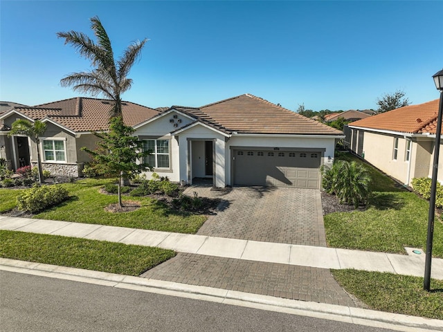 ranch-style home with a garage and a front yard