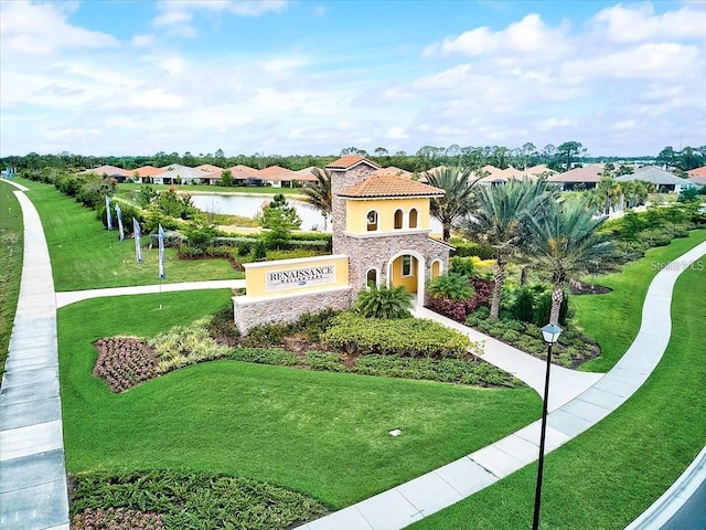 view of property's community featuring a yard and a water view