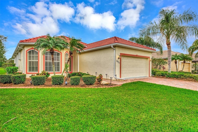 mediterranean / spanish house featuring a garage and a front lawn