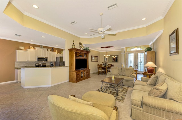 living room with french doors, light tile patterned floors, ceiling fan with notable chandelier, and ornamental molding