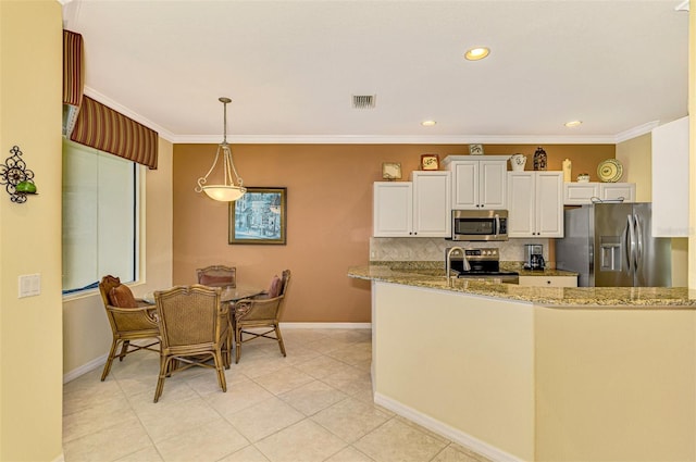 kitchen with light stone countertops, white cabinetry, hanging light fixtures, kitchen peninsula, and appliances with stainless steel finishes