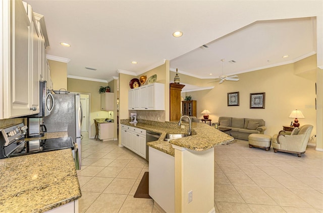 kitchen featuring kitchen peninsula, light stone counters, stainless steel appliances, ceiling fan, and sink