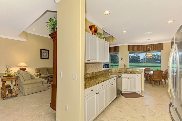 kitchen featuring white cabinetry, sink, kitchen peninsula, decorative light fixtures, and light tile patterned floors