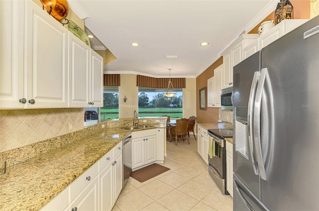 kitchen featuring pendant lighting, crown molding, sink, appliances with stainless steel finishes, and white cabinetry